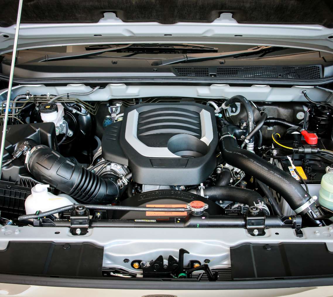 Car with hood open displaying mechanical parts