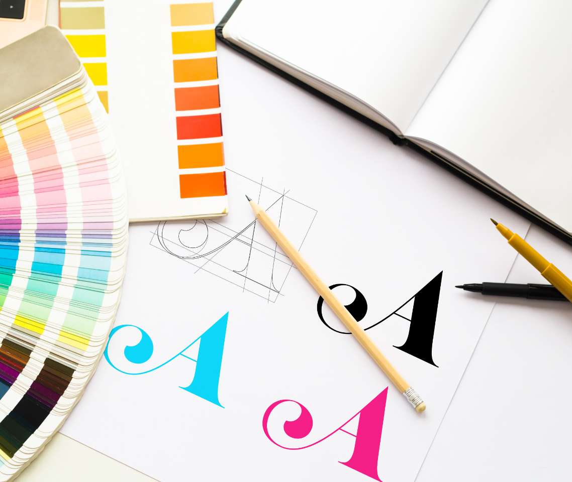 People reviewing graphic design on a table - Direct Online Marketing internet marketing company - Provider of Digital Marketing & Branding Services