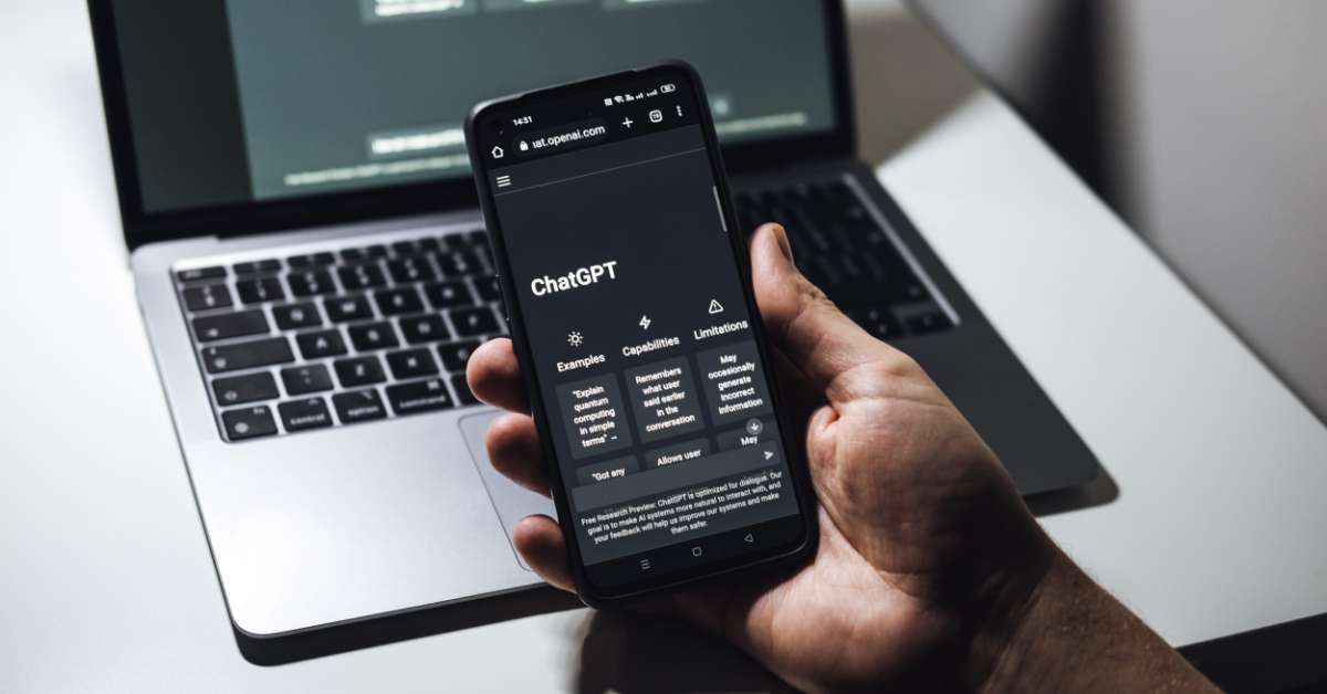 Hand holding phone displaying Chat GPT app